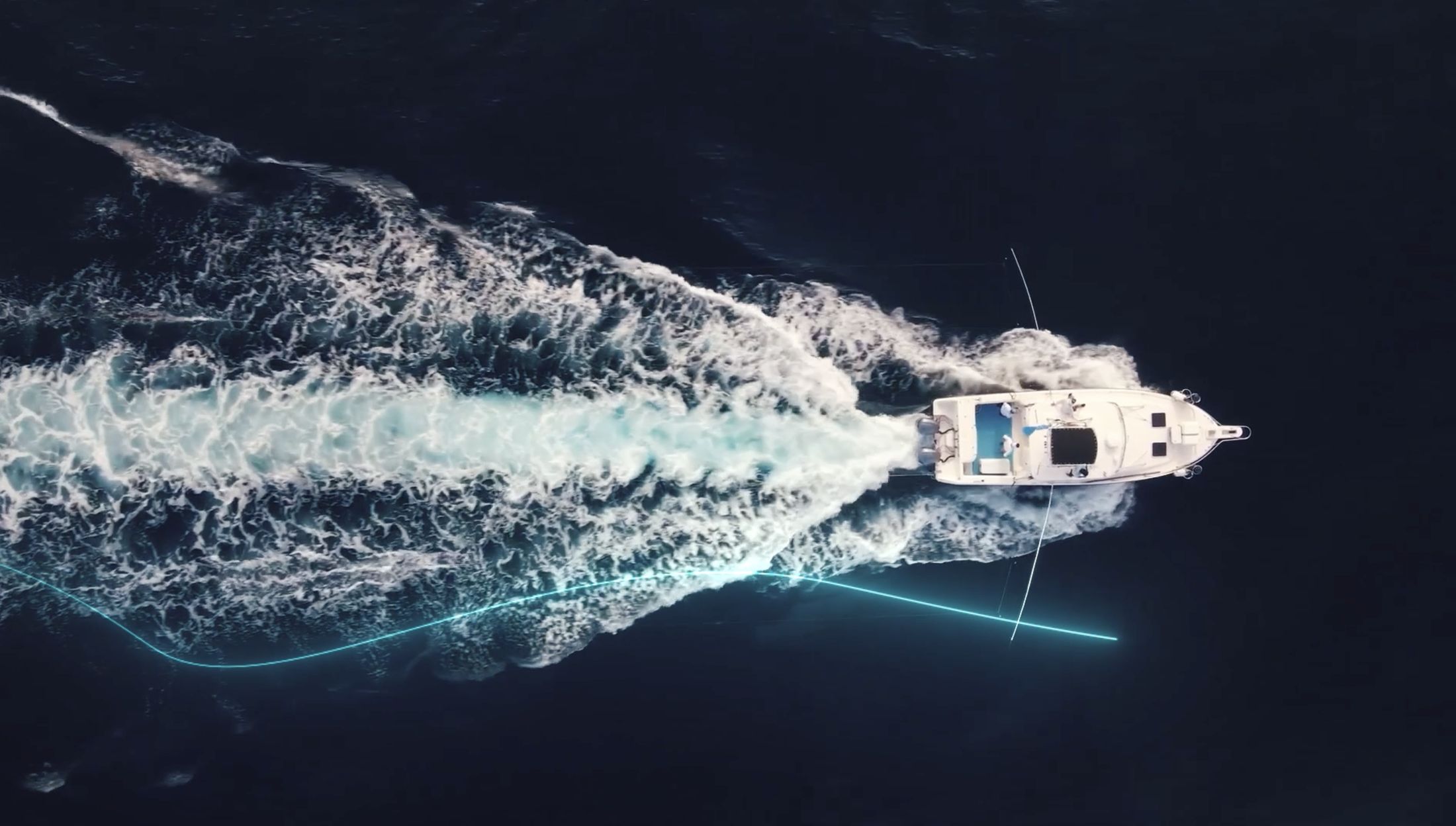 Aerial footage of a boat cutting through dark water, with a luminous cyan thread tracing its path across the frame.